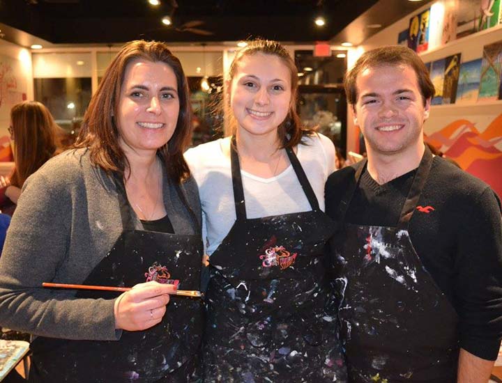 three painters at a paint & sip party