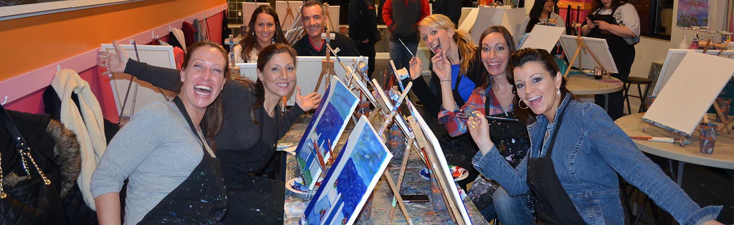 a group of people finishing their paintings at a Saratoga Paint & Sip class