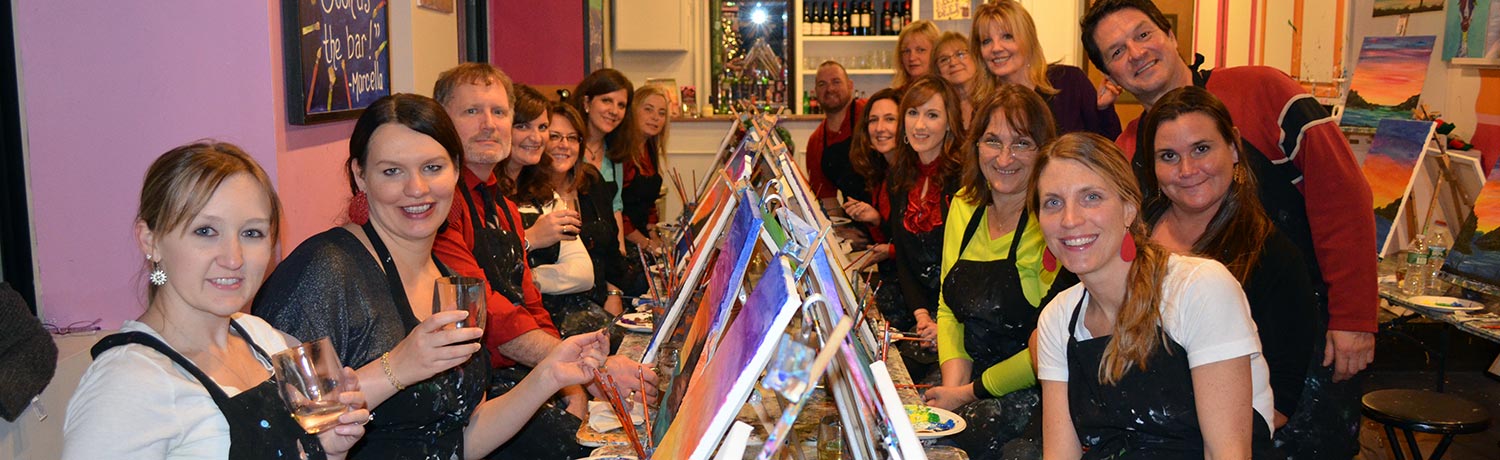 a group of people drinking and painting at one of the Paint & Sip studios
